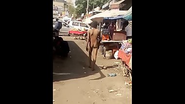 indian man roaming nude in market