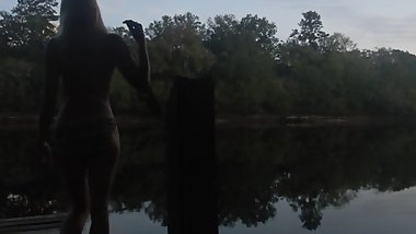 risky public sunset topless striptease over dock on river